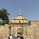 Guests going through an arched, stone entrance called the Mdina Gate in Mdina, Malta